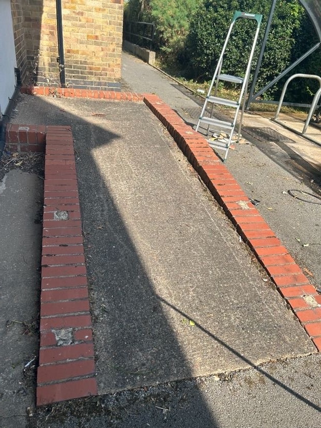 Walkway in Derby before pressure washing: green with algae and grime
